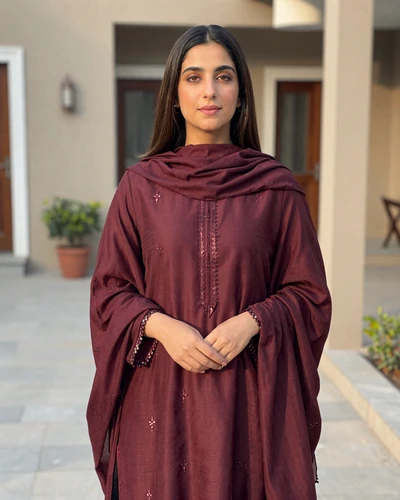 Nazia, 26, Pakistani woman from Islamabad in burgundy dupatta in courtyard